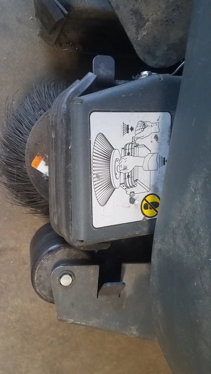 Black industrial floor brush with dense bristles and sturdy plastic housing for advance ride on carpet cleaner extractor