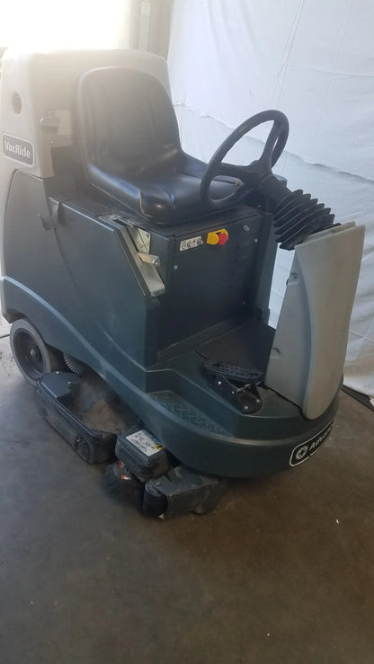 Advance ride on carpet cleaner extractor in dark green with black seat and steering wheel for heavy-duty cleaning
