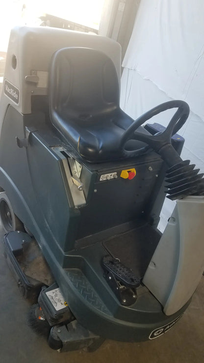 Dark green and gray advance ride on carpet cleaner extractor with black seat and steering wheel for commercial use