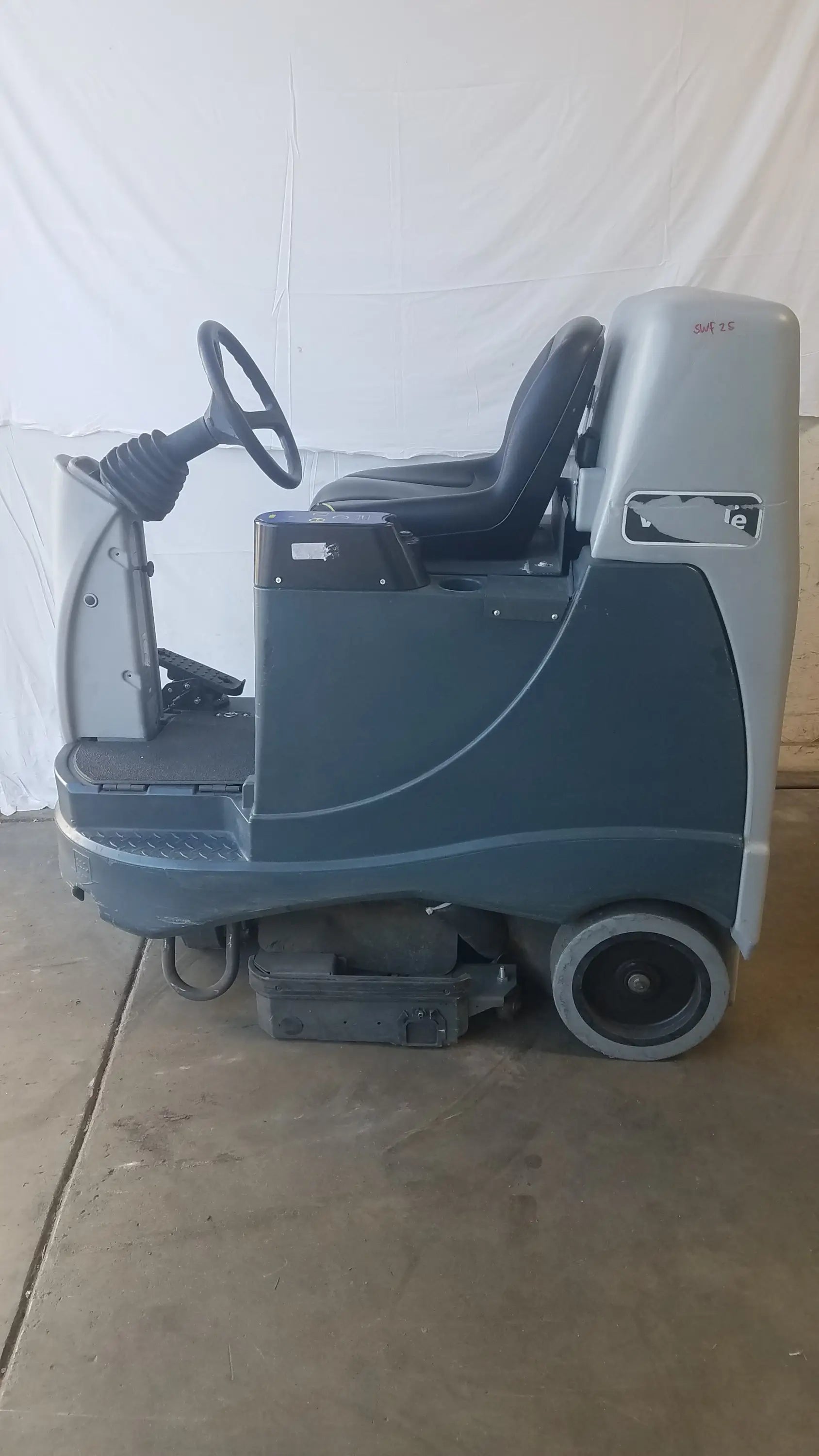 Advance ride on carpet cleaner extractor in gray and black with steering wheel and operator seat for industrial cleaning