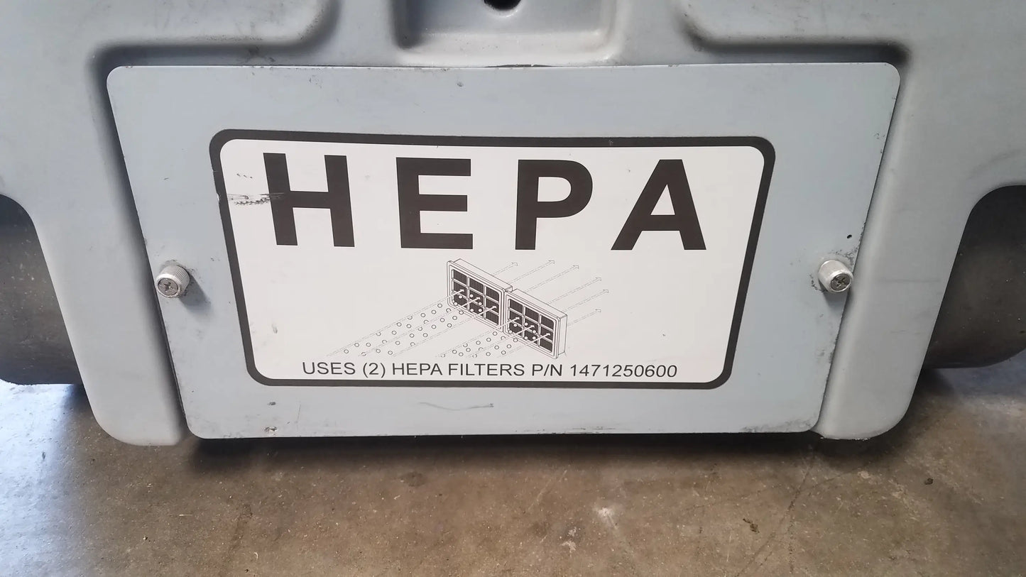 Gray plastic housing with white label reading hepa indicating two hepa filters on advance ride on carpet cleaner extractor