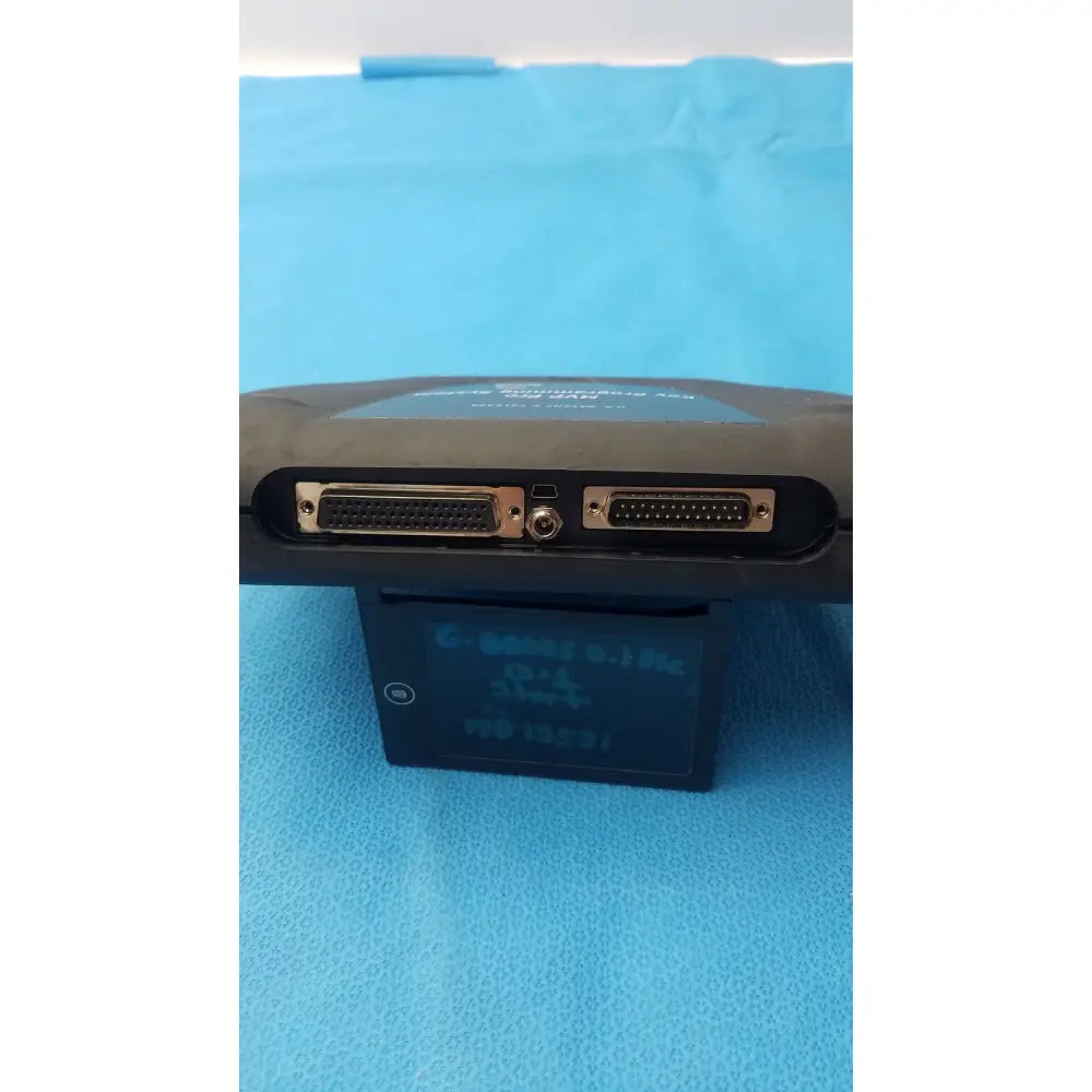 Black handheld advanced diagnostiics mvp pro device with two d-sub connectors and circular port on blue surface