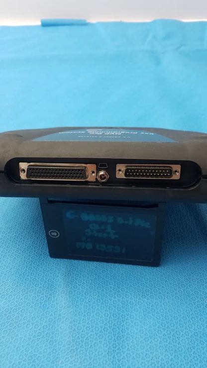 Black handheld advanced diagnostiics mvp pro device with two d-sub connectors and circular port on blue surface