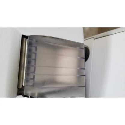 Transparent plastic roll holder with metallic core mounted on white surface for advanced sterilization products sterrad nx sterilizer