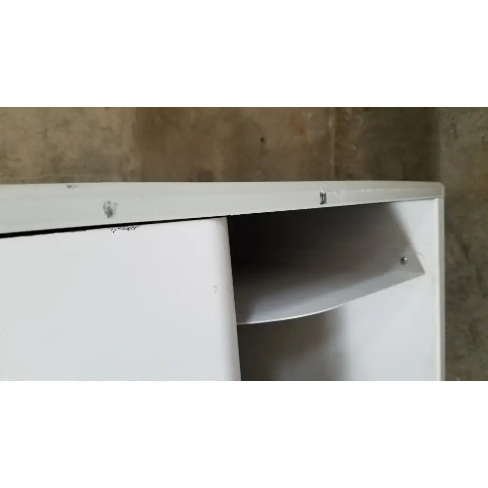 White metal cabinet with sliding door partially open revealing an interior shelf of advanced sterilization products sterrad nx sterilizer