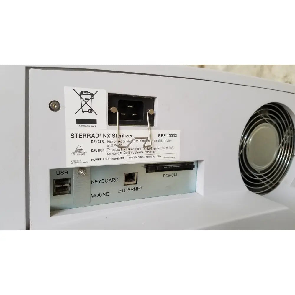 White plastic advanced sterilization products sterrad nx sterilizer back with circular vent and labeled usb keyboard ports