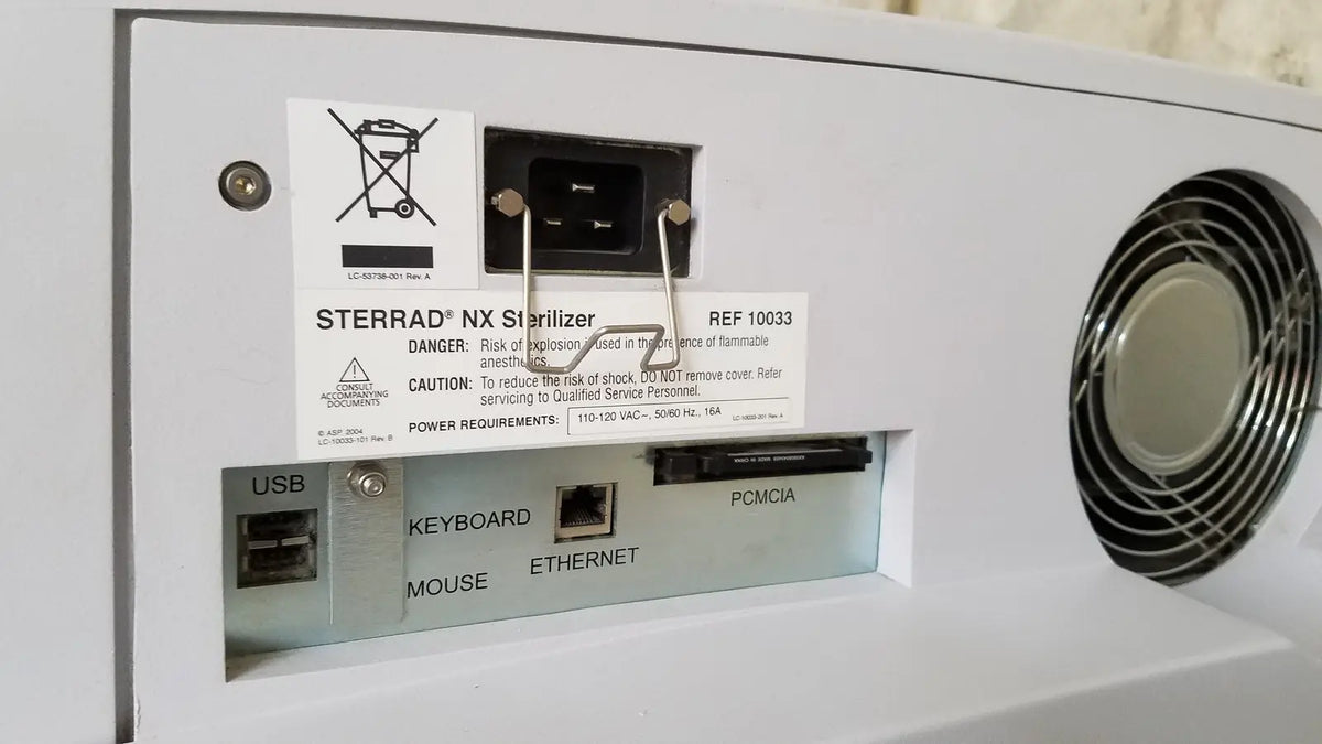 White plastic advanced sterilization products sterrad nx sterilizer back with circular vent and labeled usb keyboard ports