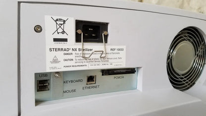 White plastic advanced sterilization products sterrad nx sterilizer back with circular vent and labeled usb keyboard ports