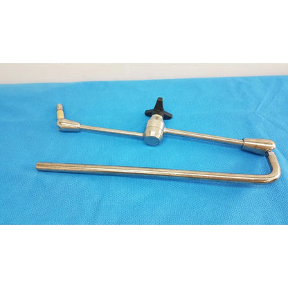 Stainless steel aesculap ff168r surgical retractor with black knob handle and articulated joint component