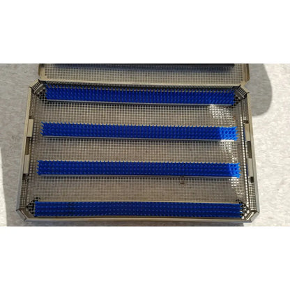 Blue silicone brush bars arranged in a metal mesh tray for aesculap jf257r jf251r sterilization case tray pn3046a modified