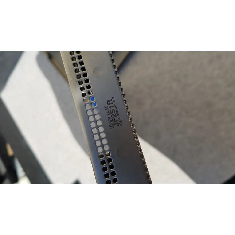 A sleek metallic kitchen knife with perforated blade engraved taschlar jf251r stainless germany for jf257r jf251r use