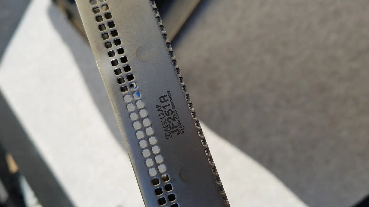 A sleek stainless steel jf257r jf251r knife blade with perforated edge and dewalt branding for aseptic use