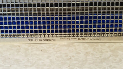 Metallic blue tinted perforated panel with square holes engraved with f on aesculap jf257r sterilization case tray pn2089a modified