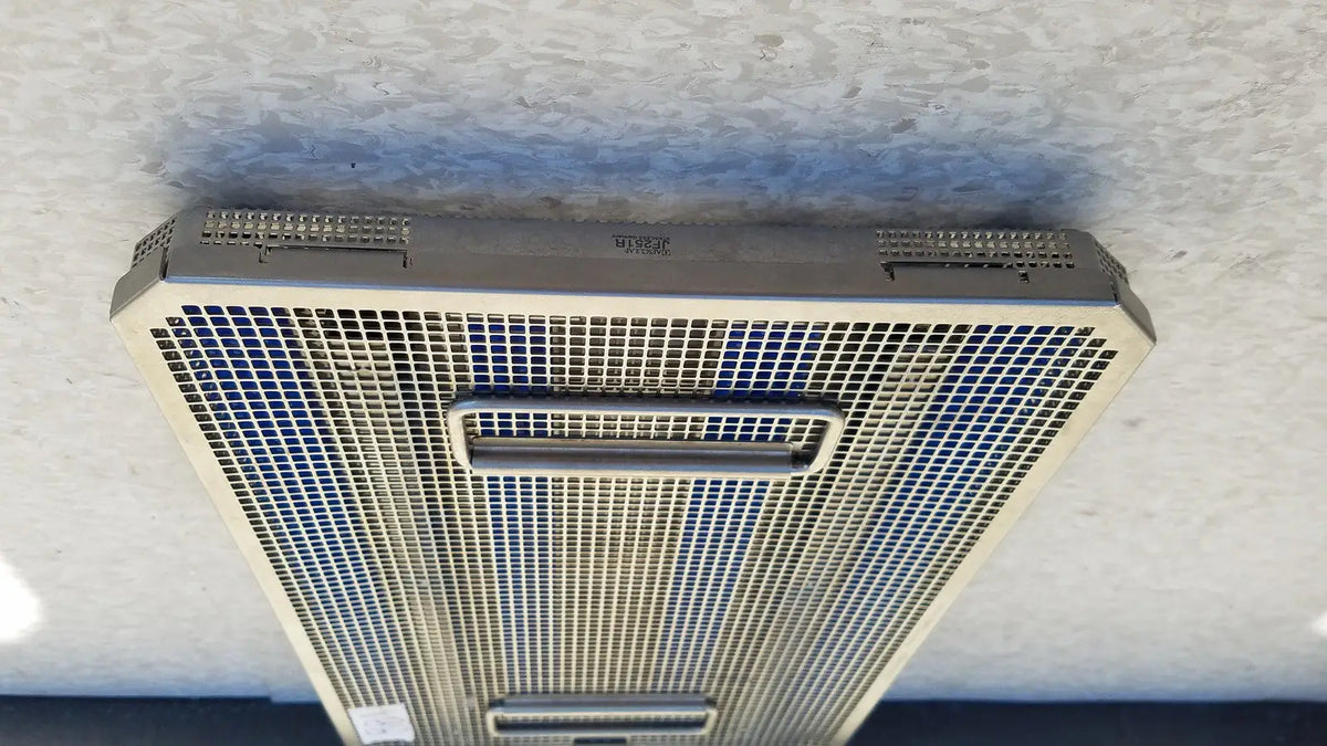 Silver metallic mesh air vent with rectangular handle and perforated grille on aesculap jf257r sterilization case tray
