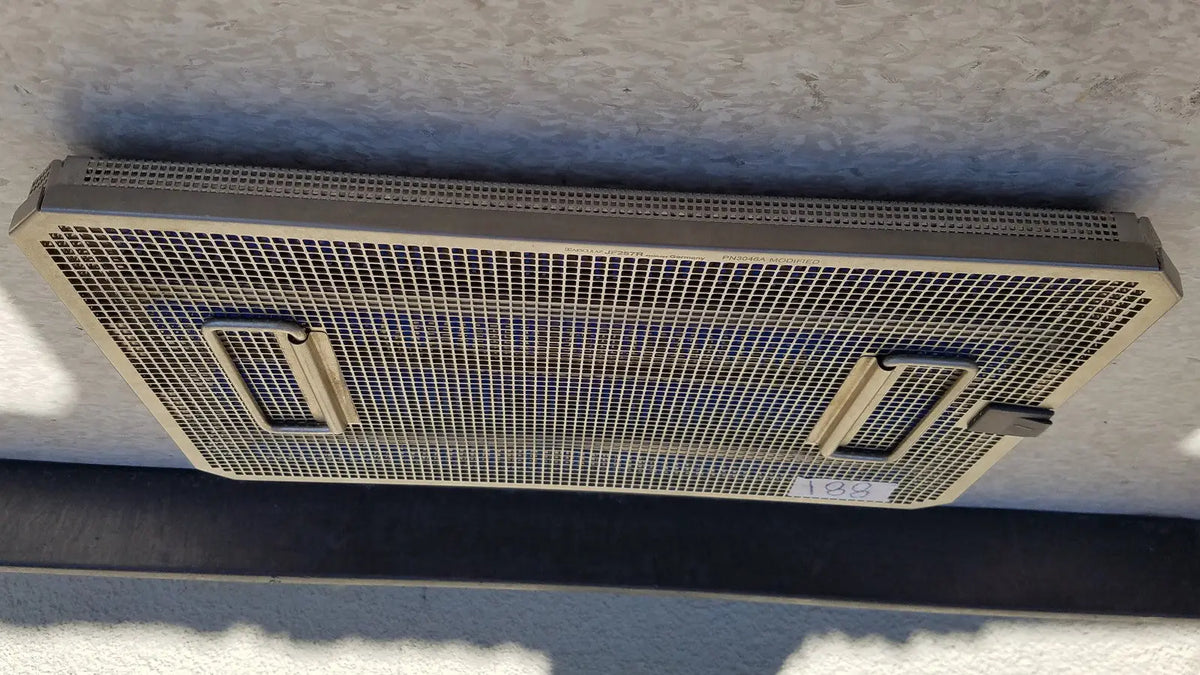 Metal mesh ventilation grille with two rectangular handles on the sides on the back of aesculap jf257r sterilization case tray pn2089a modified