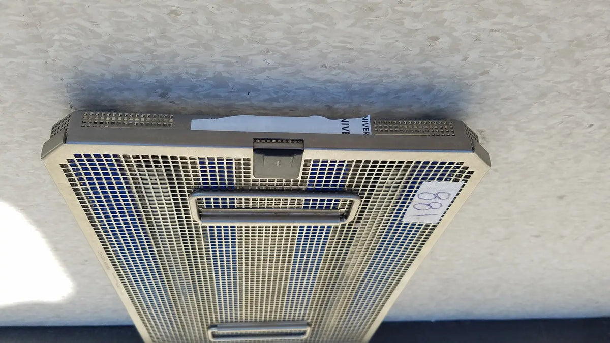 Silver-colored metal mesh air vent with rectangular grille and two handles on aesculap jf257r sterilization case tray pn2089a