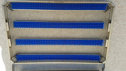 Metallic mesh aesculap jf257r sterilization case tray with four horizontal blue rubber strips for secure instrument placement