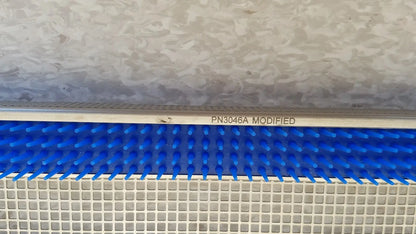 Blue plastic comb-like component with white metallic frame marked pn3046a modified for aesculap jf257r sterilization case tray