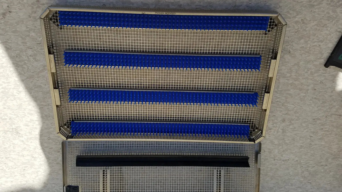 Metal mesh aesculap jf257r sterilization case tray with four blue horizontal plastic strips and one black strip at bottom