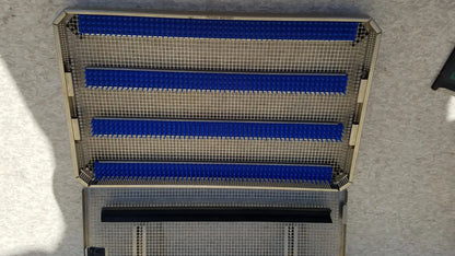Metal mesh aesculap jf257r sterilization case tray with four blue horizontal plastic strips and one black strip at bottom