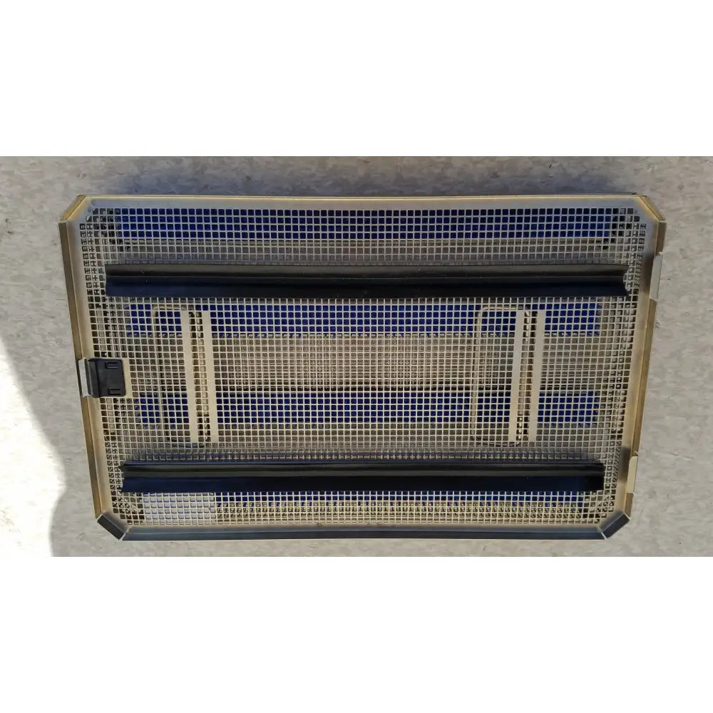 Rectangular metal mesh heater with gold-toned frame black heating elements and blue insulation panels in aesculap jf257r sterilization case tray