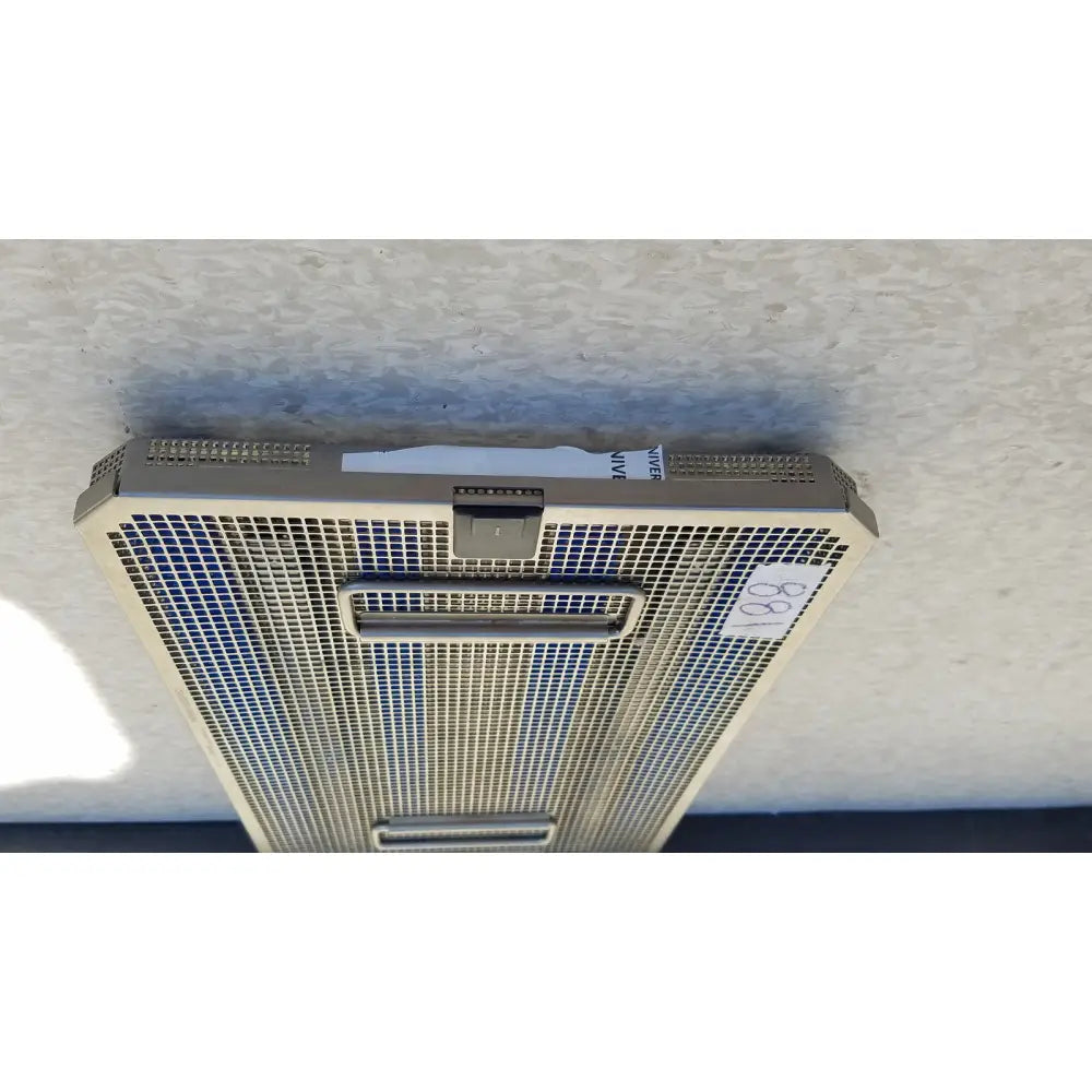 Silver-colored metal mesh air vent with rectangular grille and two handles on aesculap jf257r sterilization case tray pn2089a