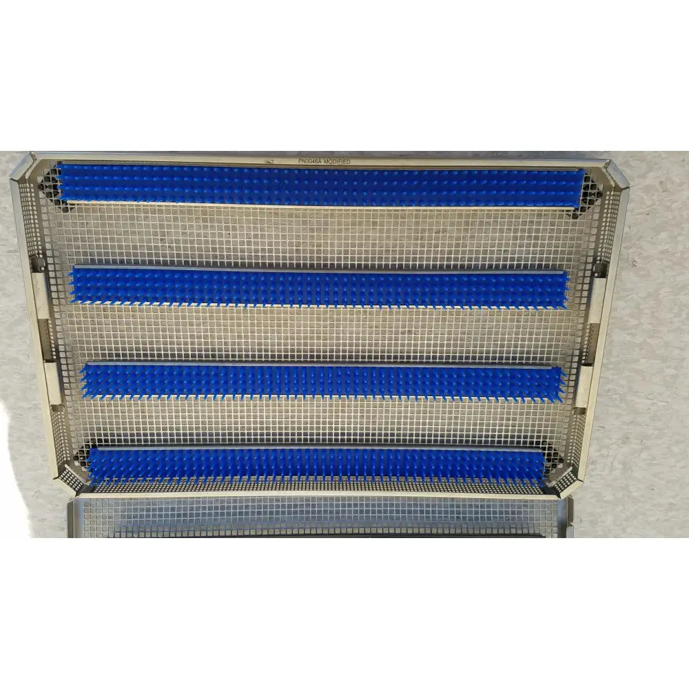 Metallic mesh aesculap jf257r sterilization case tray with four horizontal blue rubber strips for secure instrument placement