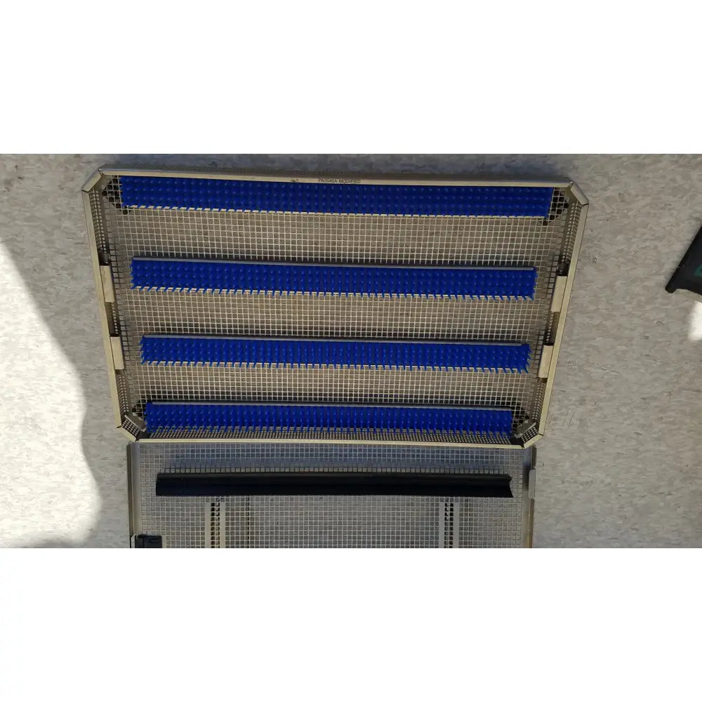 Metal mesh aesculap jf257r sterilization case tray with four blue horizontal plastic strips and one black strip at bottom