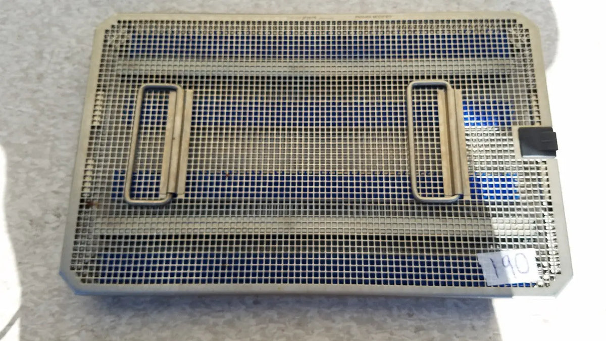 Rectangular metal mesh aesculap jf257r sterilization case tray with two side handles and black latch on one corner