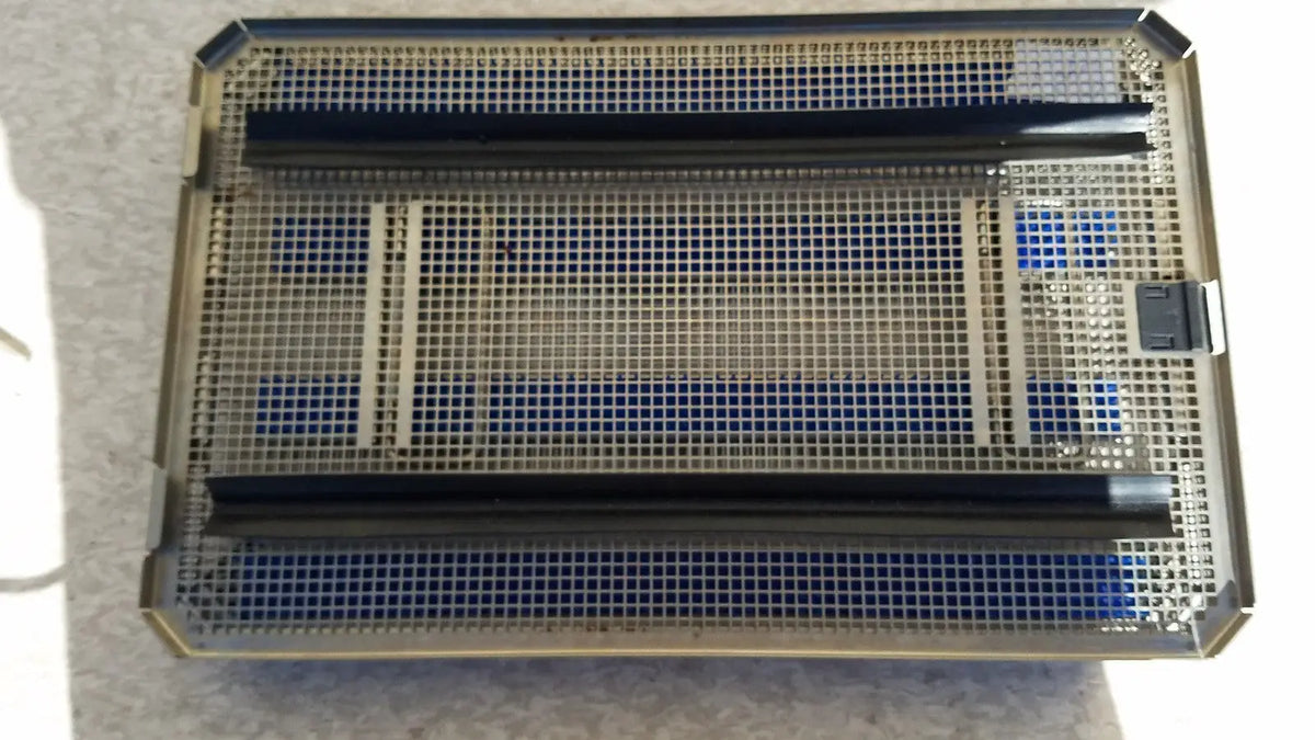 Rectangular metal aesculap jf257r sterilization case tray with black plastic dividers and blue foam inserts for surgical use
