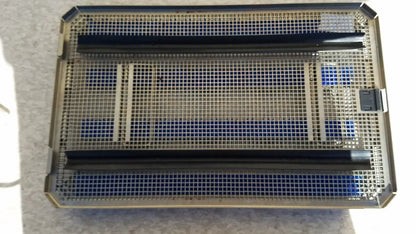 Rectangular metal aesculap jf257r sterilization case tray with black plastic dividers and blue foam inserts for surgical use