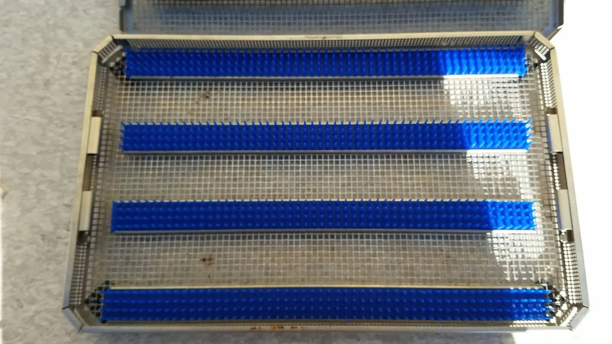Blue plastic dental impression trays placed in a metal mesh jf257r sterilization case tray aesculap jf257r sterilization