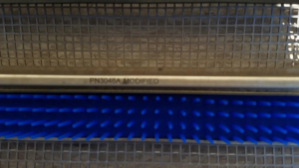 Blue bristle brush with metallic handle labeled pk3046a modified for aesculap jf257r sterilization case tray pn3046a modified