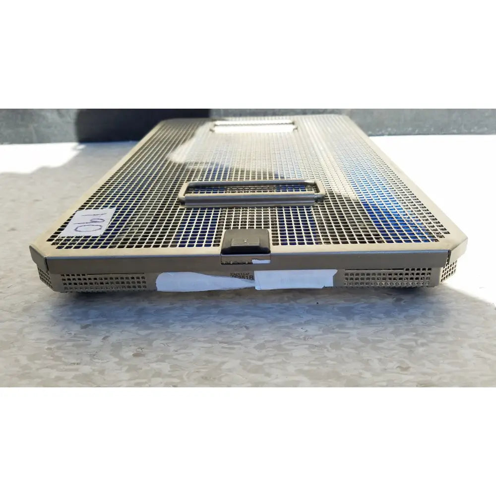 Tan metal mesh aesculap jf257r sterilization case tray with handle and latch for surgical instrument sterilization