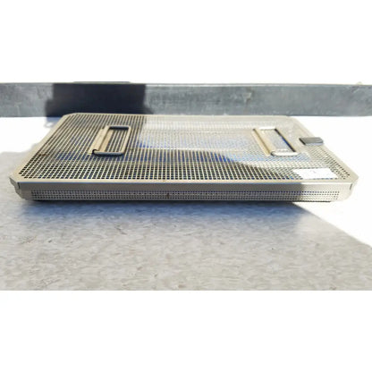 Rectangular stainless steel aesculap jf257r sterilization case tray with perforated mesh surface and two handles