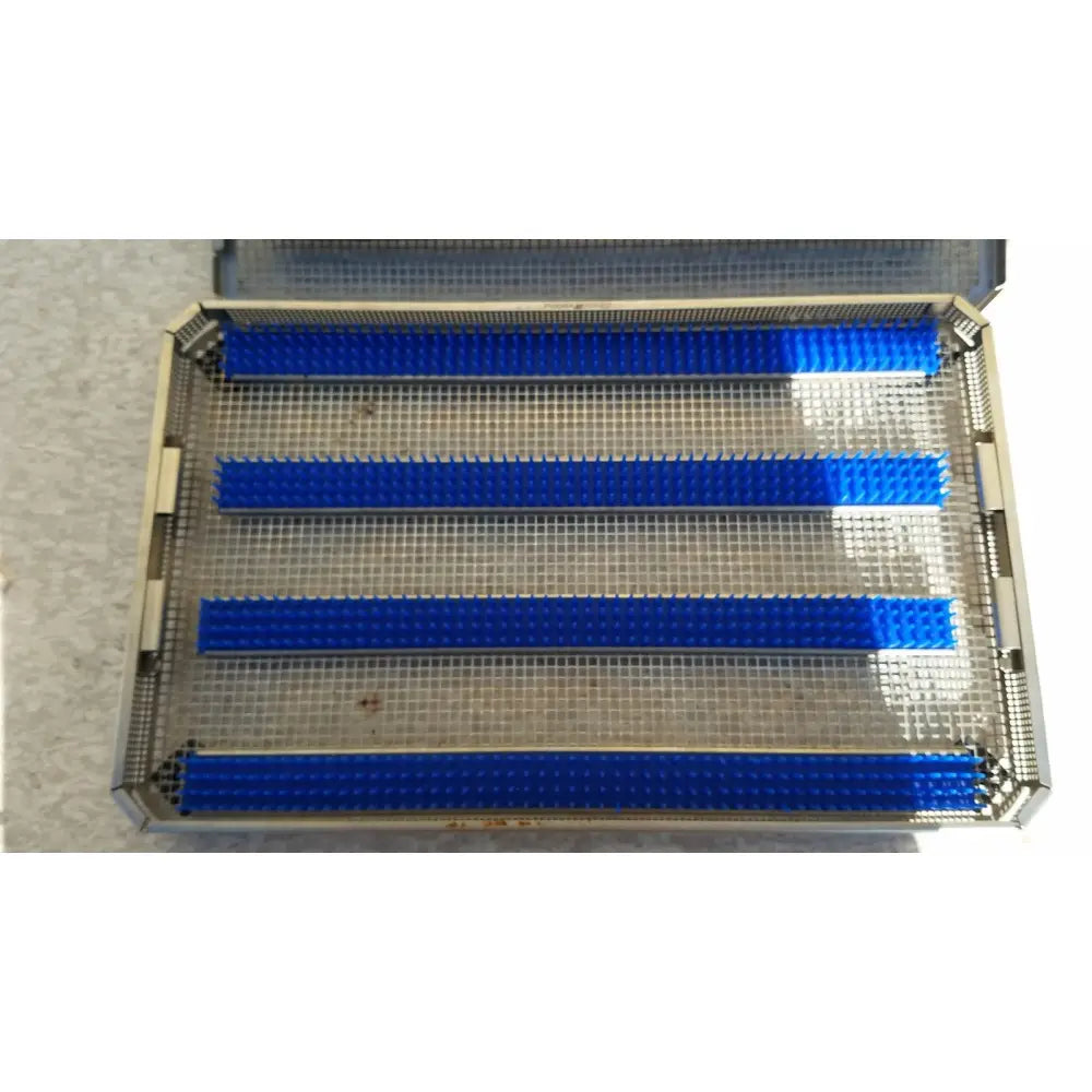 Blue plastic dental impression trays placed in a metal mesh jf257r sterilization case tray aesculap jf257r sterilization