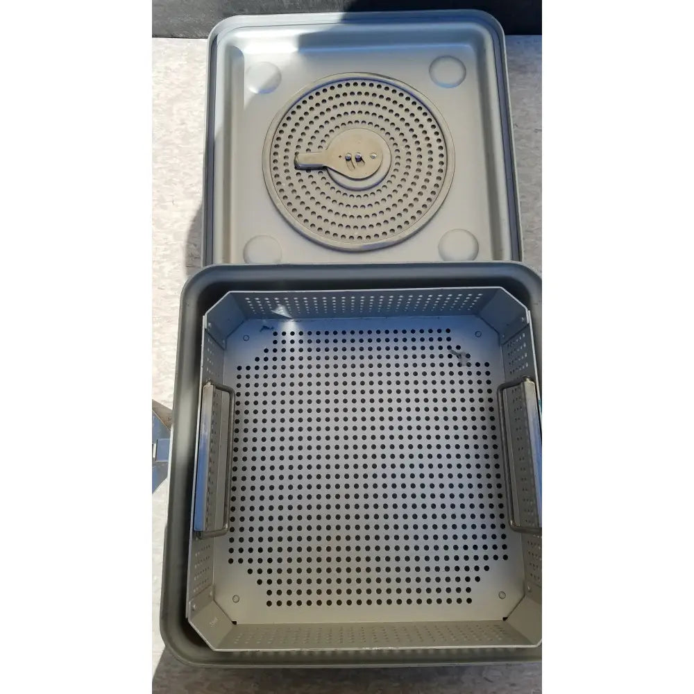 Gray metal aesculap jk341 half size sterilization case with perforated tray and circular component for surgical use