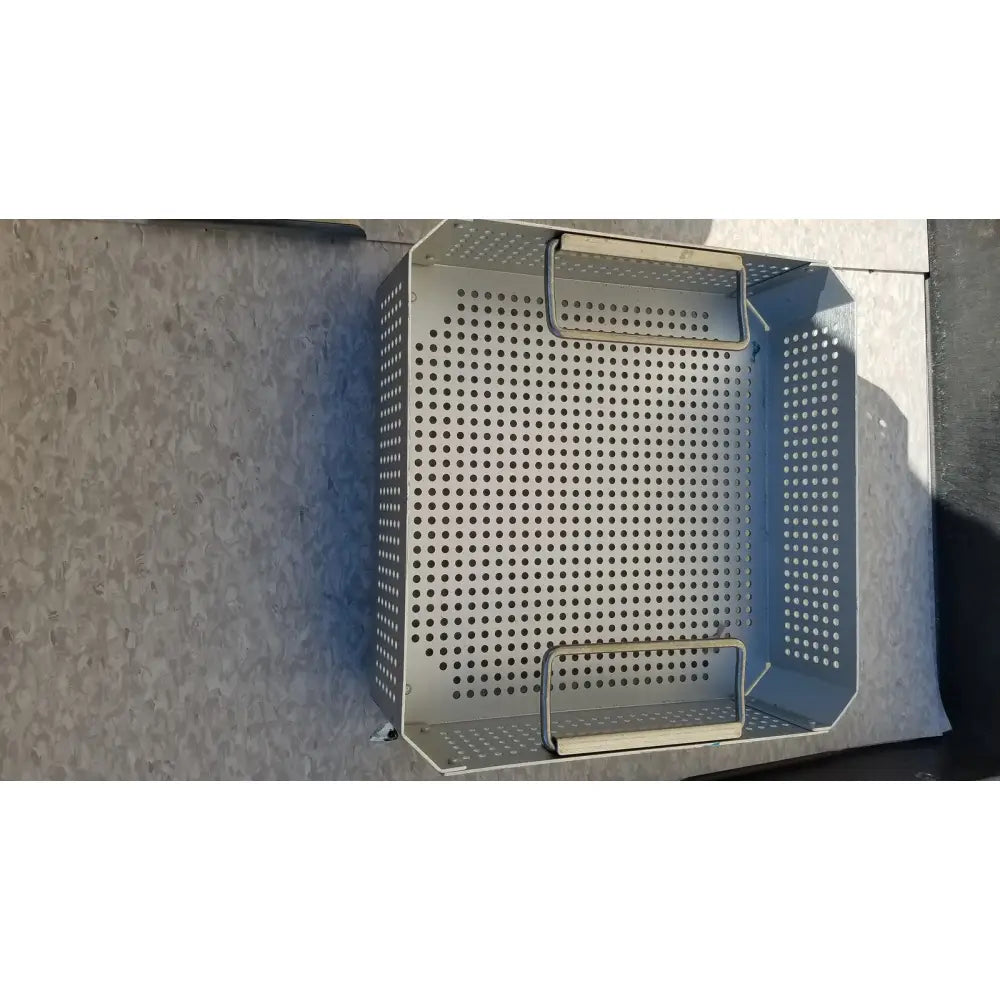 Silver perforated metal baking pan with two handles for aesculap jk341 half size sterilization case and lid