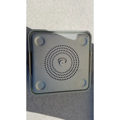 Gray plastic aesculap jk341 half size sterilization case speaker with circular perforations and central button