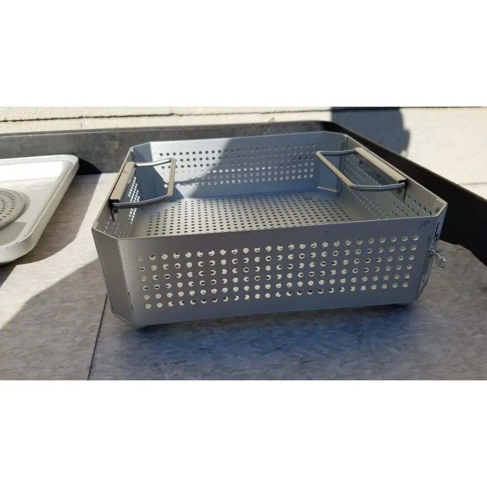 Gray perforated metal baking pan with reinforced handles for aesculap jk341 half size sterilization use