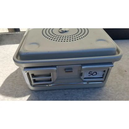 Gray plastic aesculap jk341 half size sterilization case with perforated lid and numbered slot for secure storage