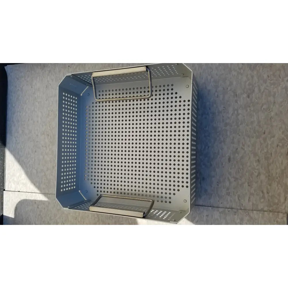 Silver perforated metal grill basket with handle and base tray in aesculap jk341 half size sterilization case
