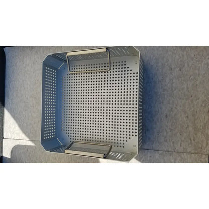 Silver perforated metal grill basket with handle and base tray in aesculap jk341 half size sterilization case