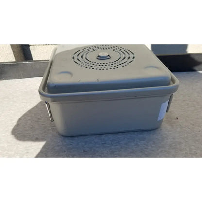 Gray plastic aesculap jk341 half size sterilization case with perforated lid and metal latch for secure closure