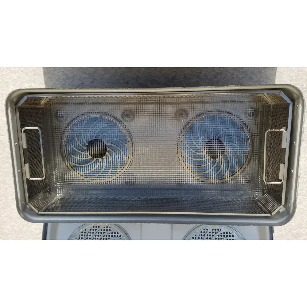 Rectangular stainless steel mesh basket with two circular blue fan blades inside aesculap jk489 jk442 sterilization container