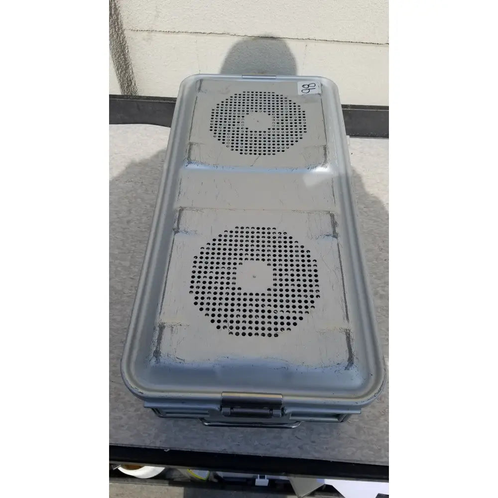 Gray plastic aesculap jk489 jk442 sterilization container case with two circular perforated panels and a metal latch