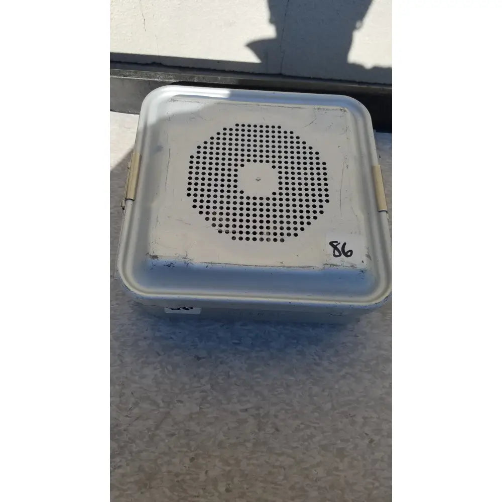White plastic aesculap jn340 instrument sterilization container with circular perforated grille and 86 marked on lid