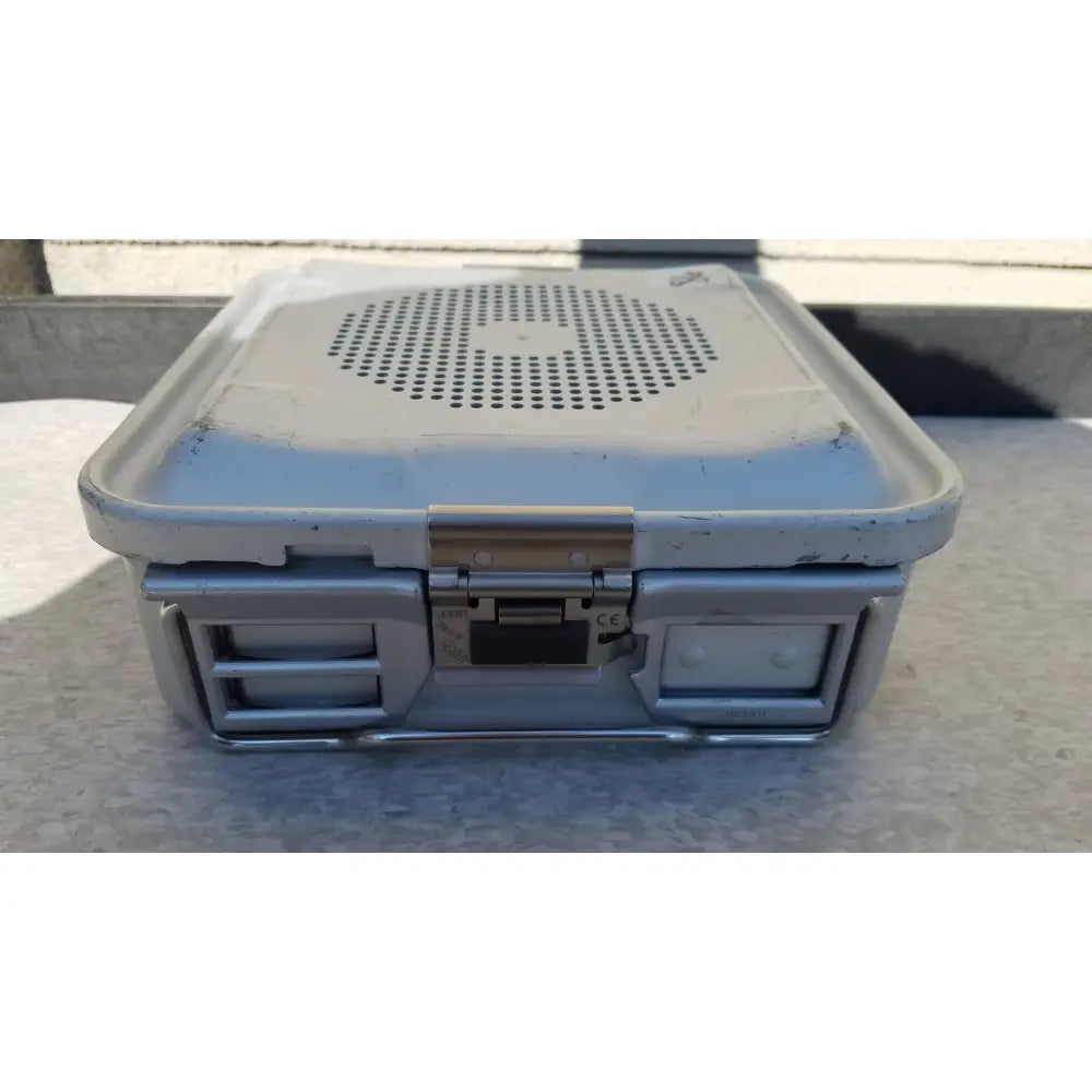 Silver-gray rugged plastic and metal aesculap jn340 instrument sterilization container tray with perforated lid and latch mechanism