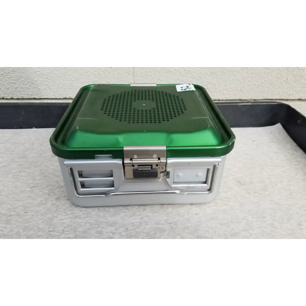 Green and silver aesculap jn341 sterilization container with perforated metal lid for surgical instrument sterilization