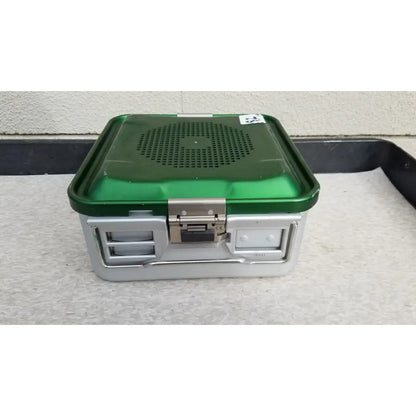 Green and silver aesculap jn341 sterilization container with perforated metal lid for surgical instrument sterilization